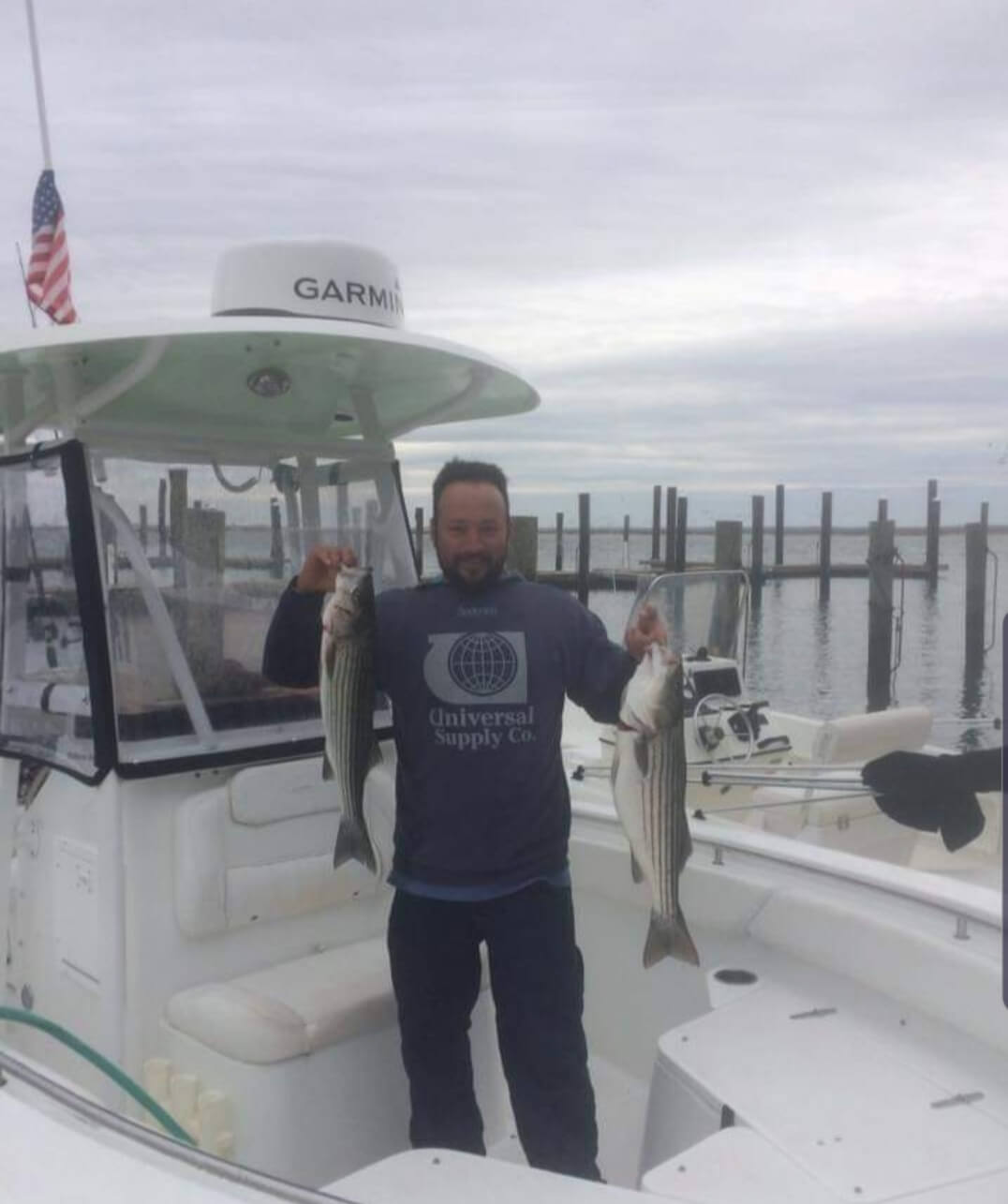 A happy angler and his two stripers.