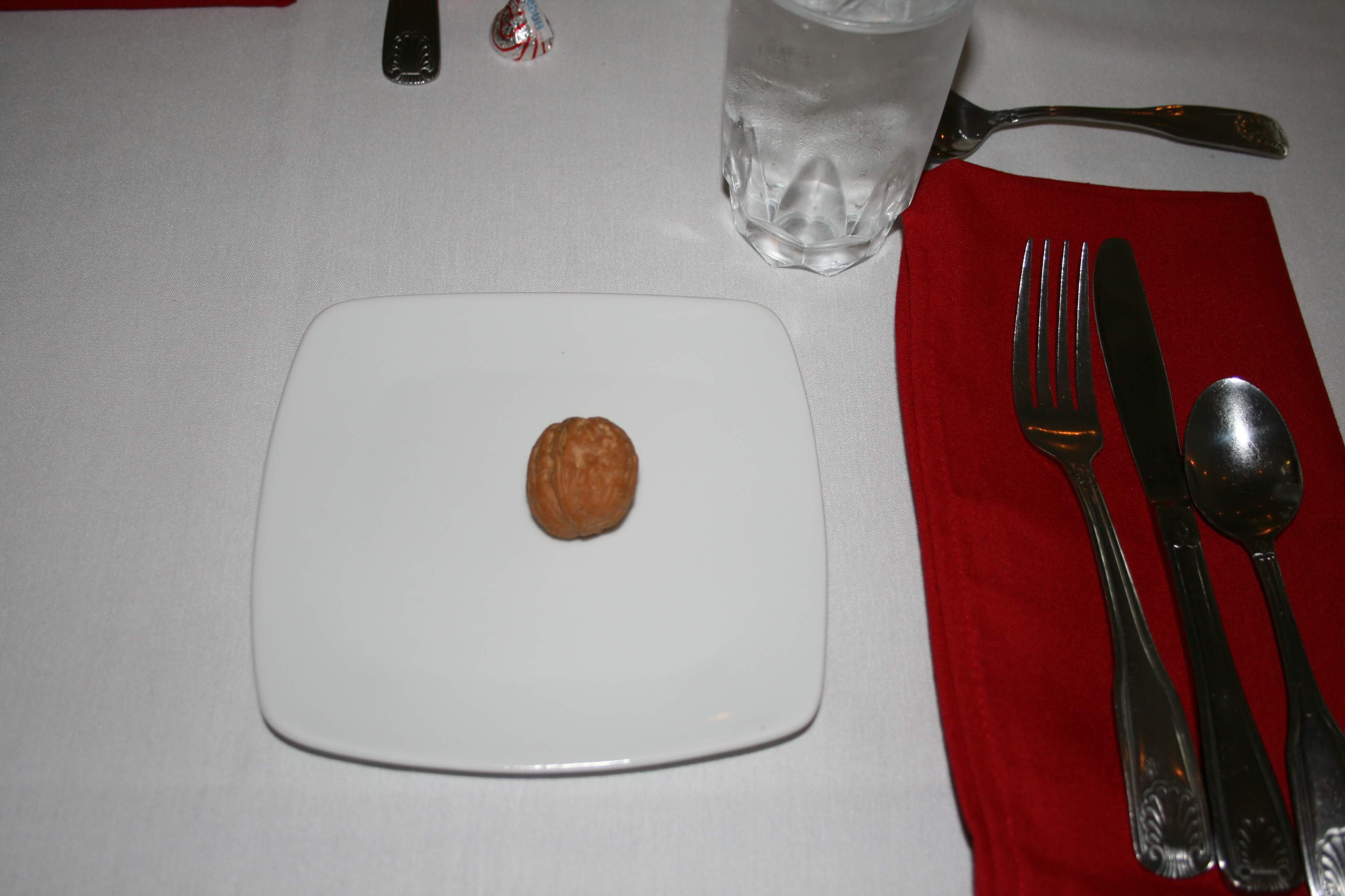 Each place setting at the luncheon to honor Battle of the Bulge veterans included a single walnut on a stark