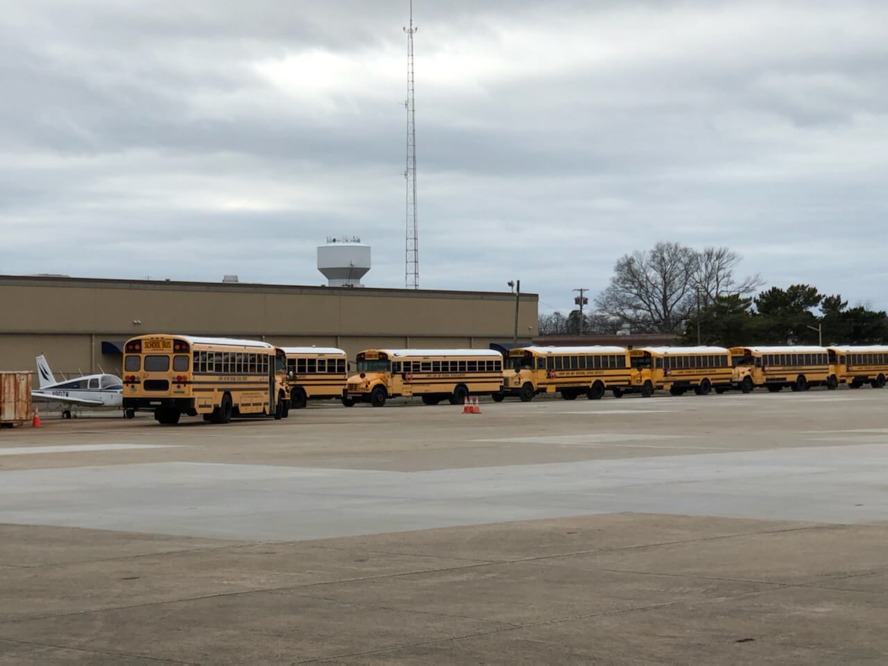 A line of school buses provide security for the landing zone at the Cape May County Airport