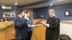 Michael Donohue swears in James Norris with his wife