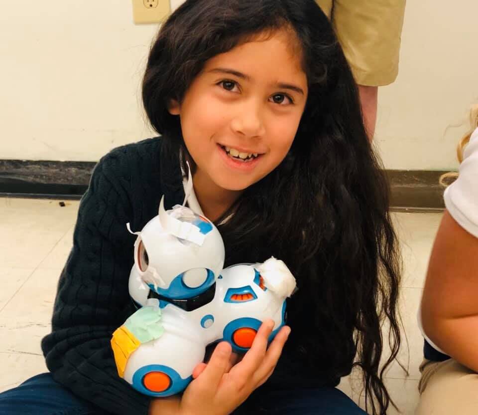 Fourth-grader and 4-H Robotics Team member Jasmine Sheik poses with Dash