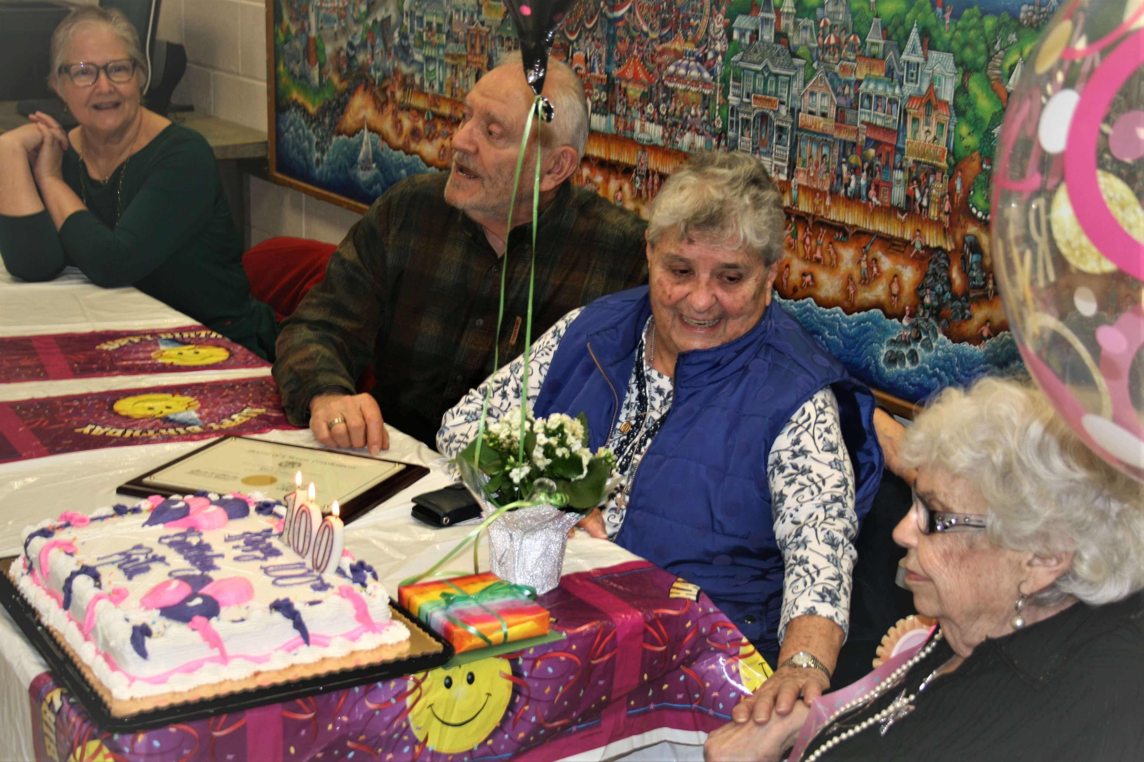 Members of Rita Lomas’ family helped her celebrate her 100th birthday with gifts and a cake.