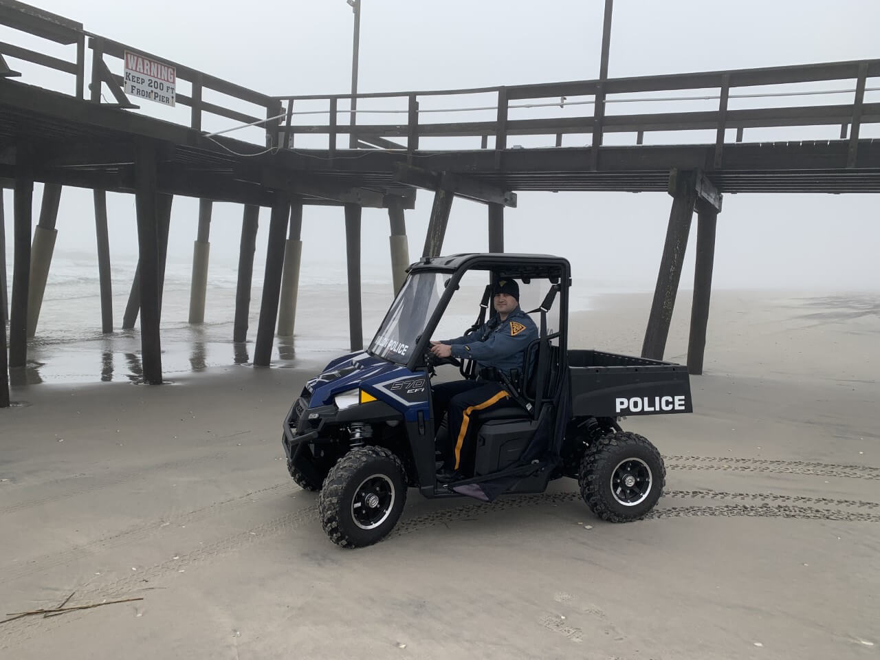 Avalon Police Officer Nick Brady behind the wheel of the department's beach vehicle that is used to patrol and spot alcohol users along the oceanfront.