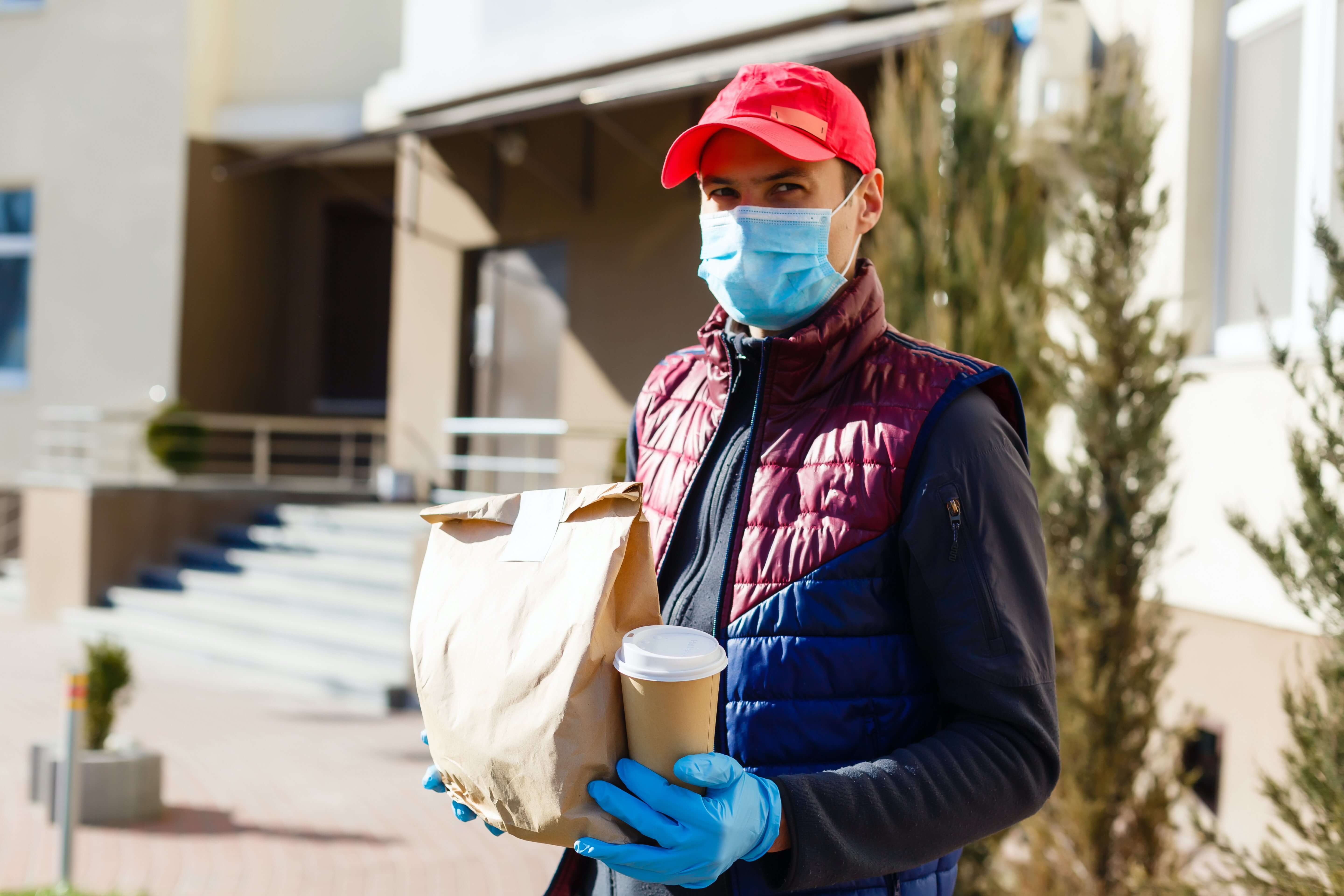 A delivery driver wears protective equipment to protect against the spread of the coronavirus. 