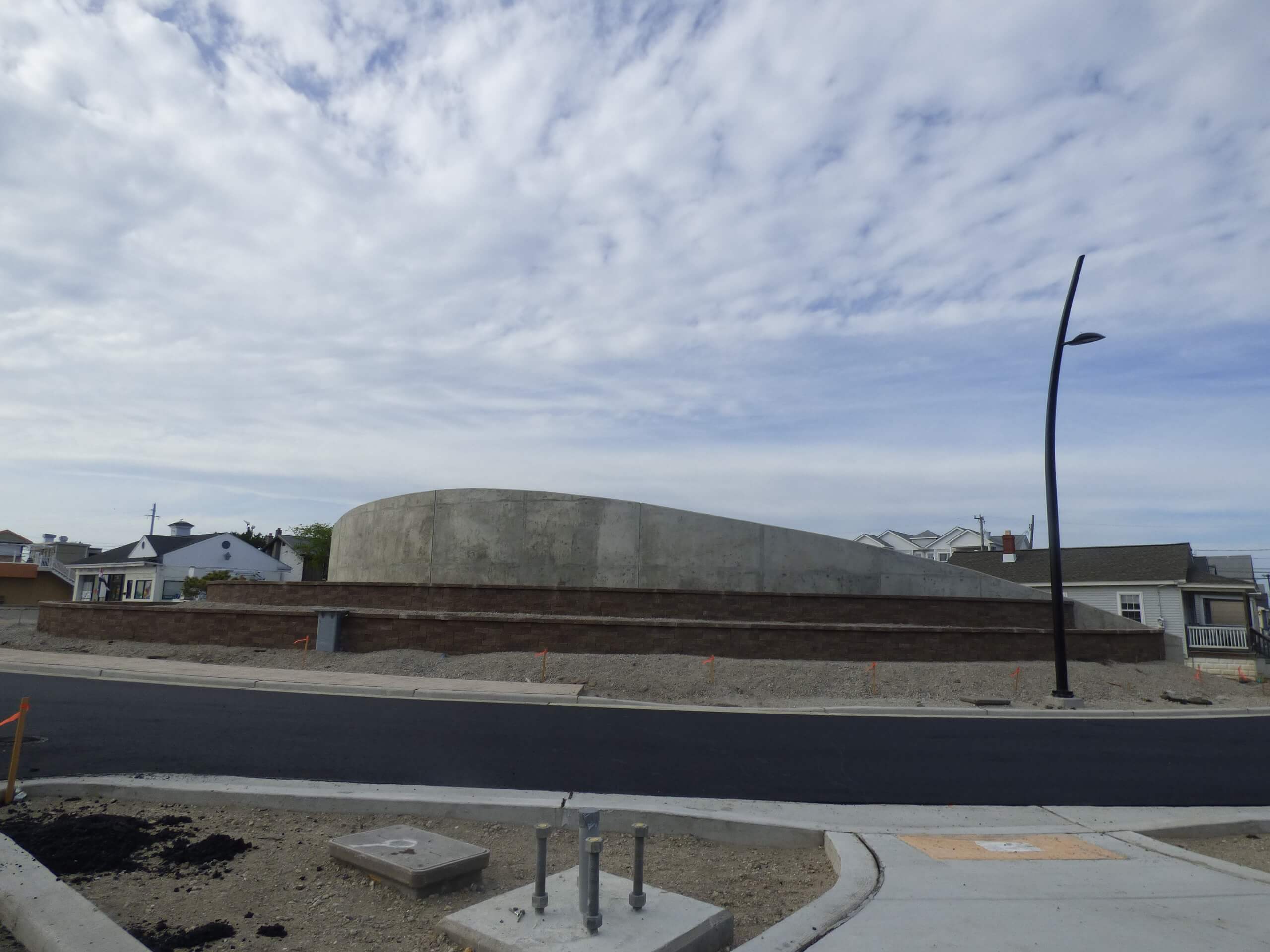 The facade on the concrete wall that conceals the new pumping station will not be done in time for Memorial Day weekend