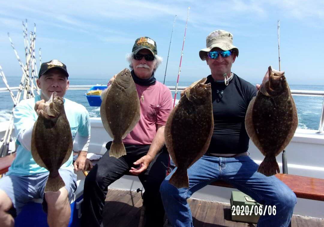 Happy anglers and their flounder.