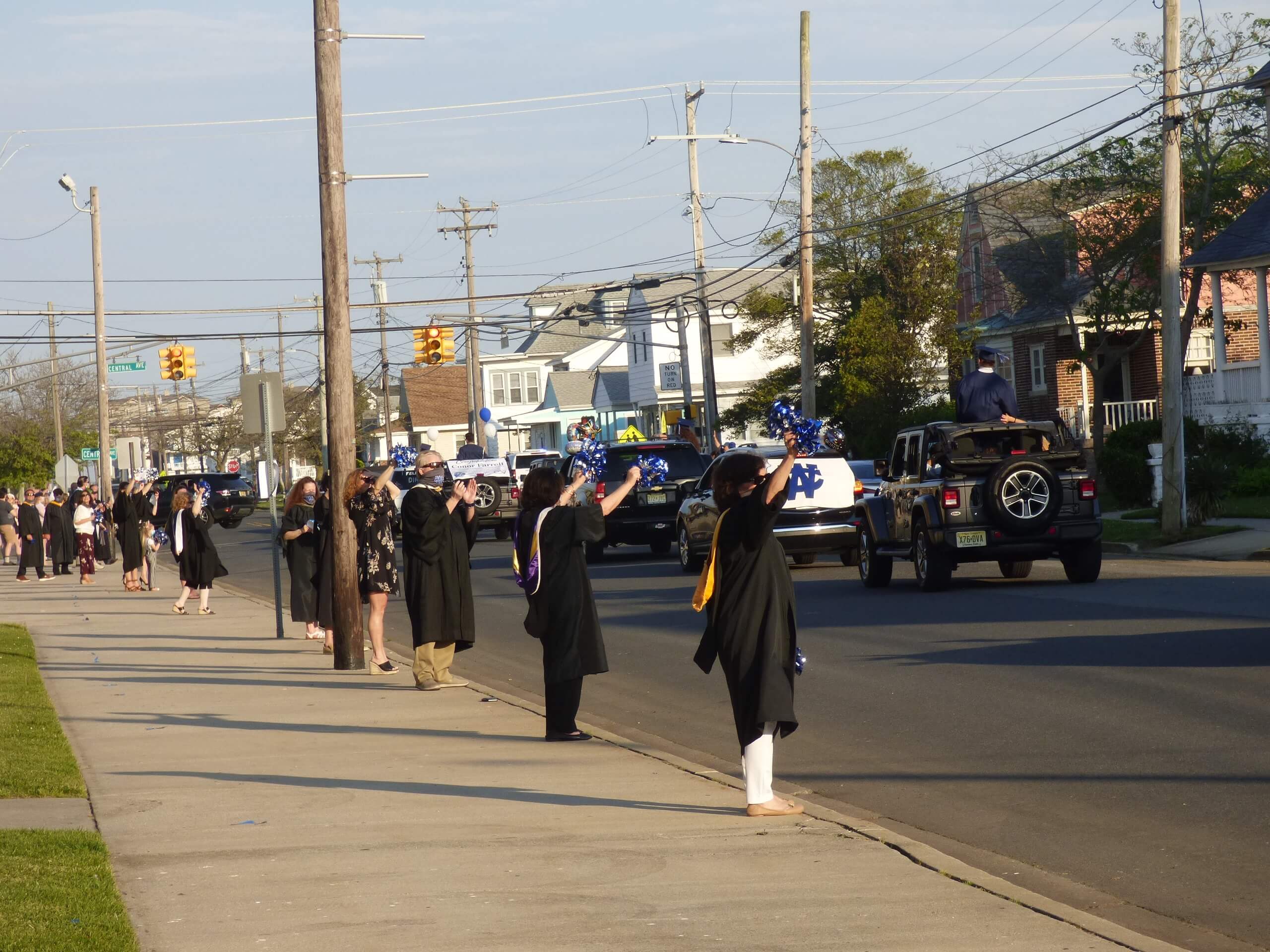 Wildwood Catholic faculty lined 16th Avenue in caps and gowns to congratulate the class of 2020 as they drove by the school. The graduation ceremony was held as a drive-by as in-person ceremonies are banned due to concerns over the spread of coronavirus.