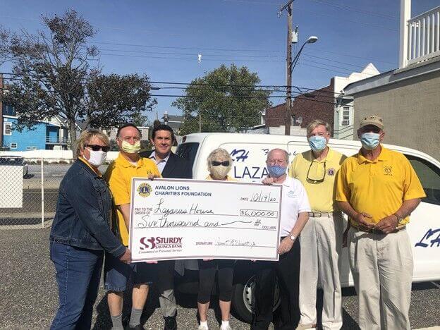 Officers and members of the Avalon Lions Club present a check for $6