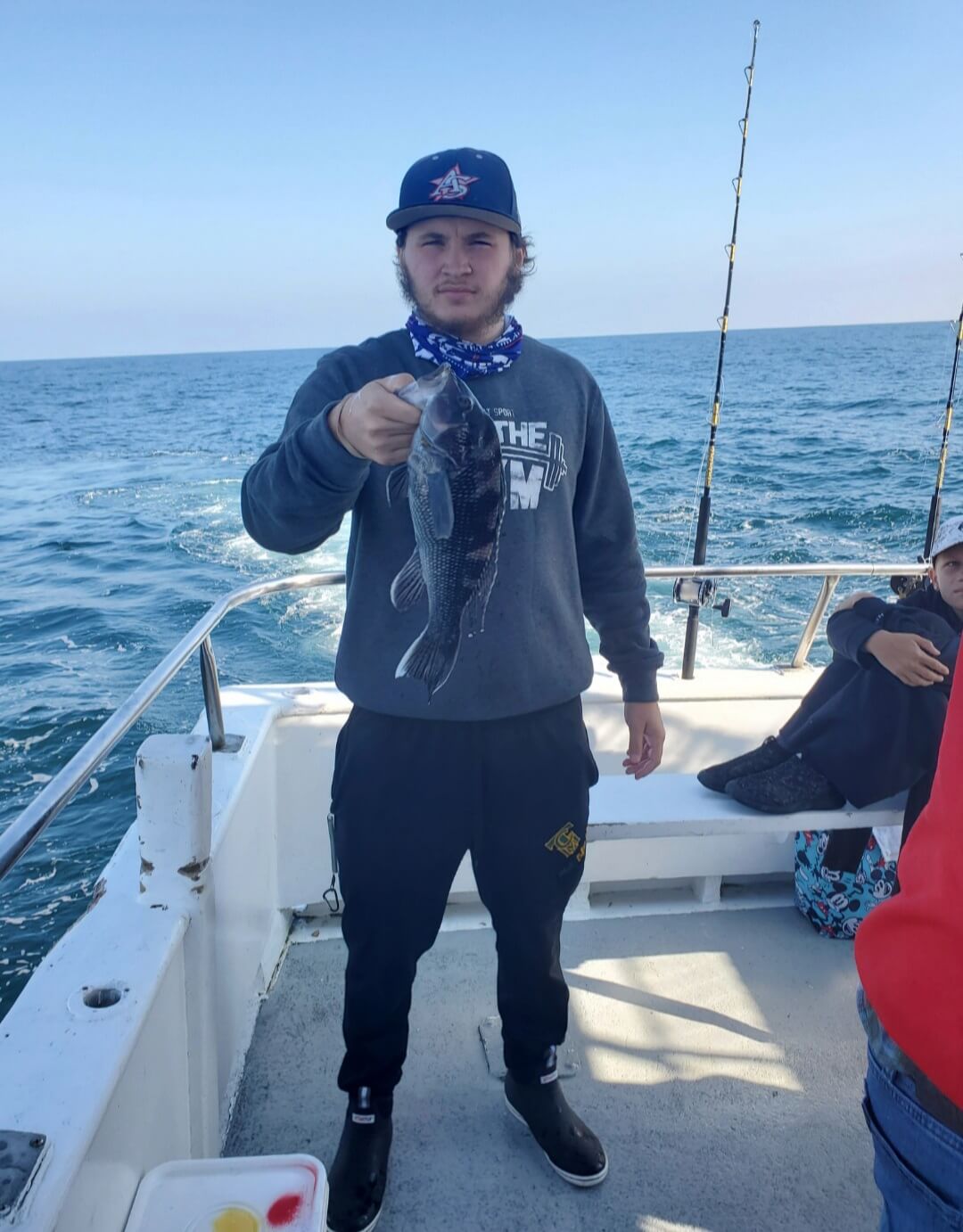 A happy angler and his keeper sea bass.