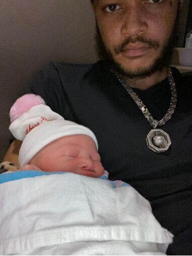 Desmond Causey-Jones holding his newborn daughter
