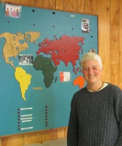 Debby Amundsen stands by the mission map in the First Baptist Church of Anglesea. She is committed to spreading the love of Jesus at home and abroad. 