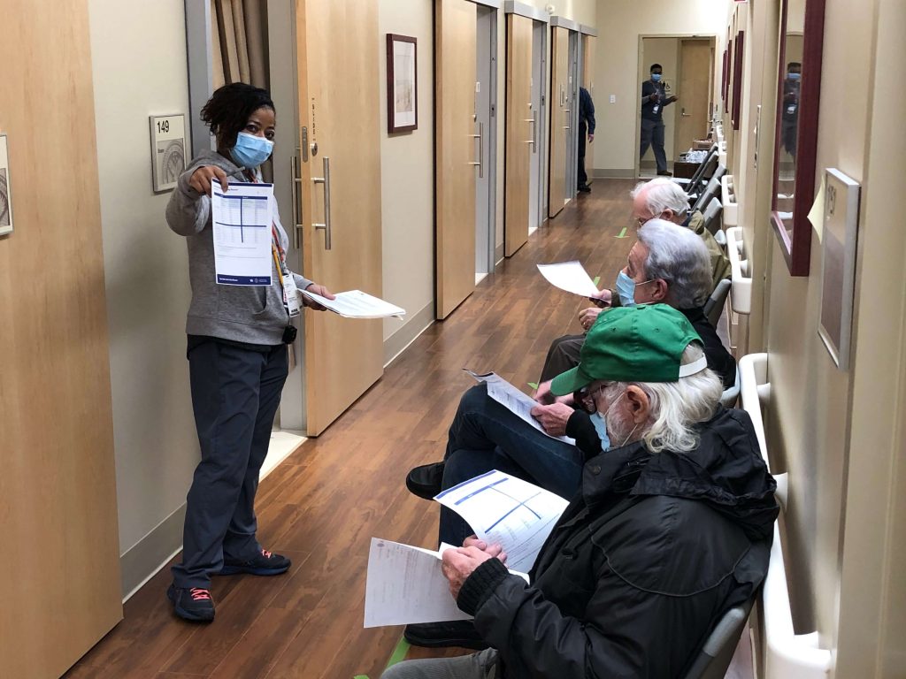 Veterans wait through their 15 minutes of post-vaccination observation at the U.S. Department of Veterans Affairs (VA) Cape May County Community Based Outpatient Clinic