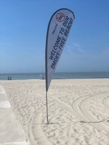 Flags at Cape May beach entrances remind beachgoers to stay smoke-free.