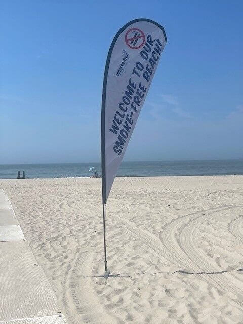 Flags at Cape May beach entrances remind beachgoers to stay smoke-free.