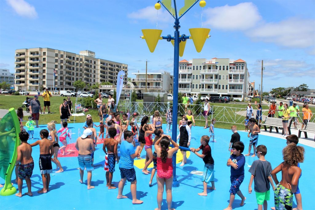 Dozens of children play in the new splash pad after the completion of the grand reopening ceremony at Wildwood Crest’s Sunrise Park at Rambler Road.
