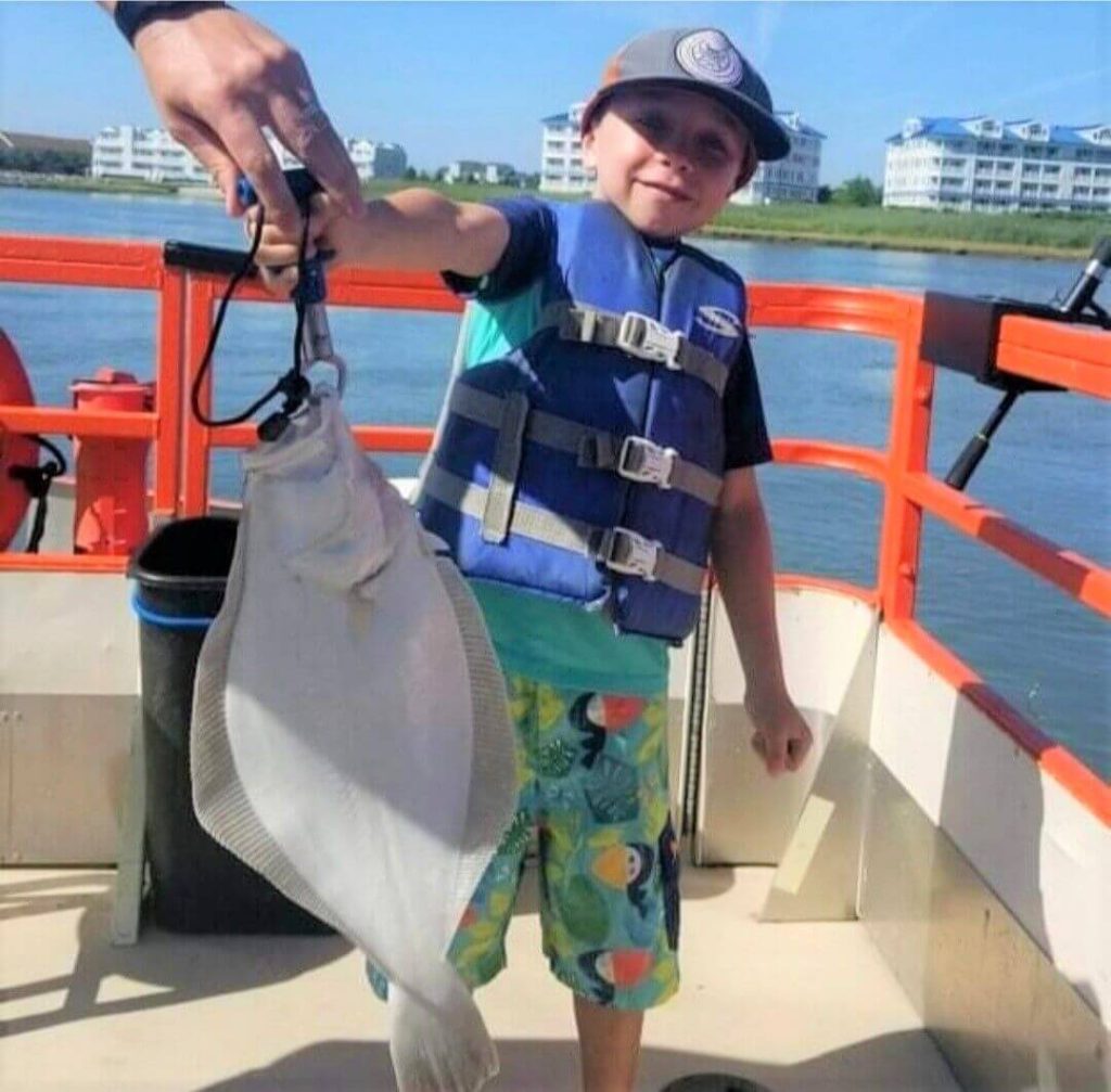 A proud young angler and his catch.
