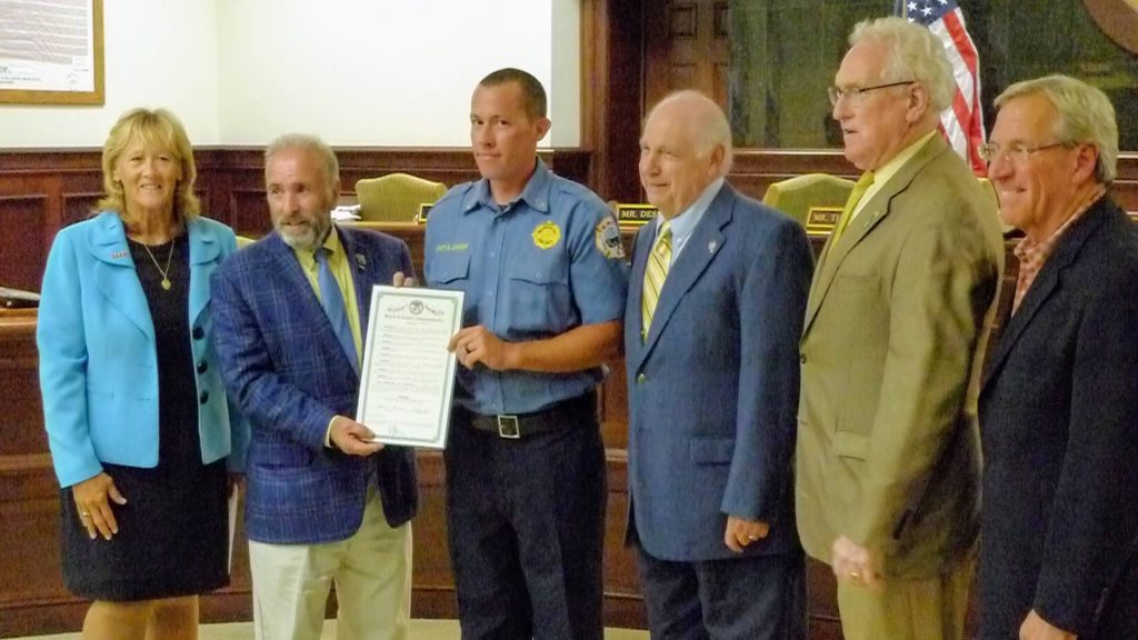 Wildwood Fire Department Capt. Matt Johnson accepts a resolution from County Commissioner Vice-Director and Public Safety Director Leonard Desiderio Aug. 24 for being one of 80 from New Jersey