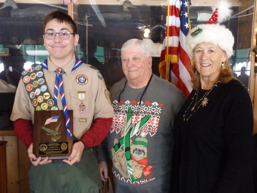 Left to right Zachary DuFault and Johnny Walker stand with Cape May County Commissioner Marie Hays. 