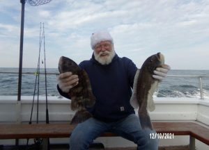 Paul Bodkin and two of his four keeper blackfish. 