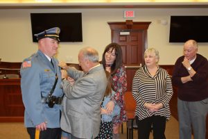 Thomas McQuillen had his badge pinned on by Mayor Leonard Desiderio as his family looked on when he was first sworn as chief in 2018.