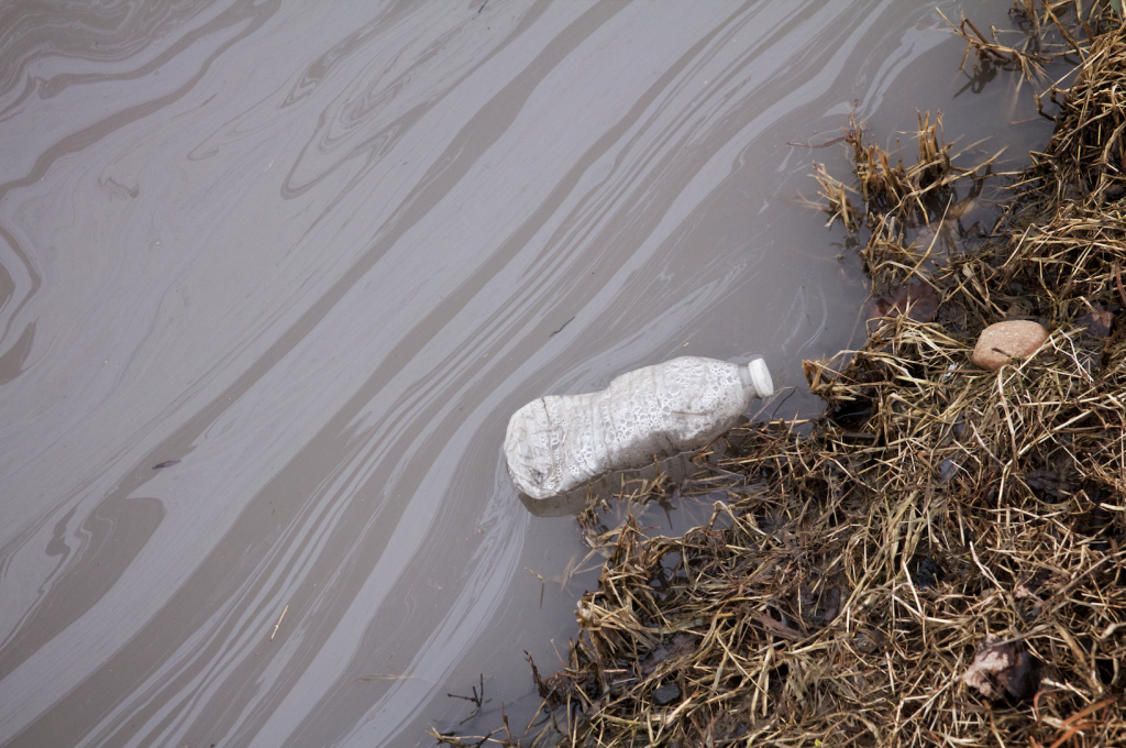 A plastic water bottle sits in a stream. NJ has one of the worst PFA issues in the nation.