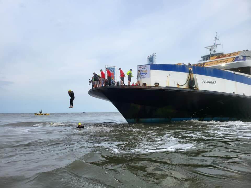 A participant is seen jumping off the Cape May-Lewes Ferry into the Delaware Bay for the annual Escape the Cape Triathlon