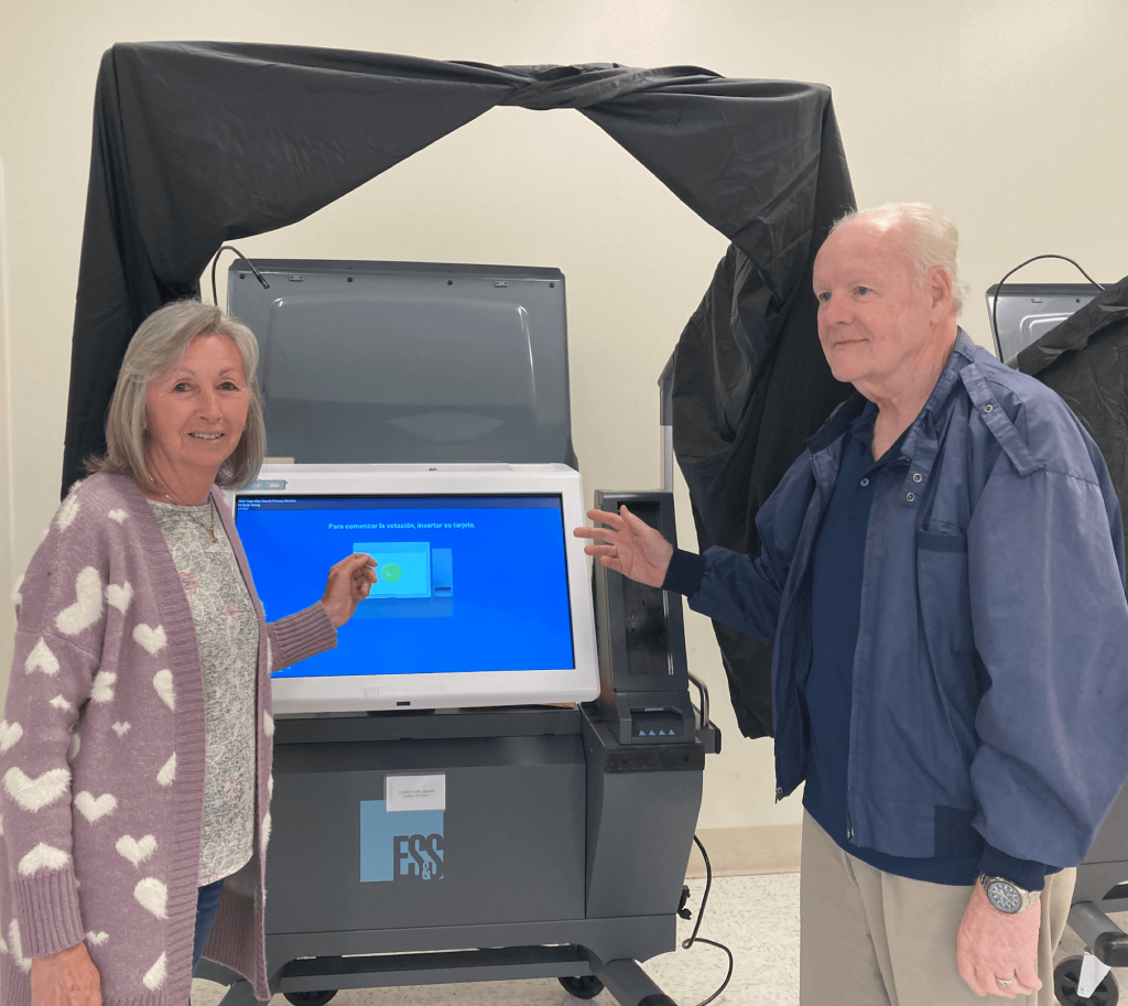 Poll workers pose with a voting machine at the Lower Cape Library in Villas. Early voting began June 3 and continues through June 5. Election day is June 7.