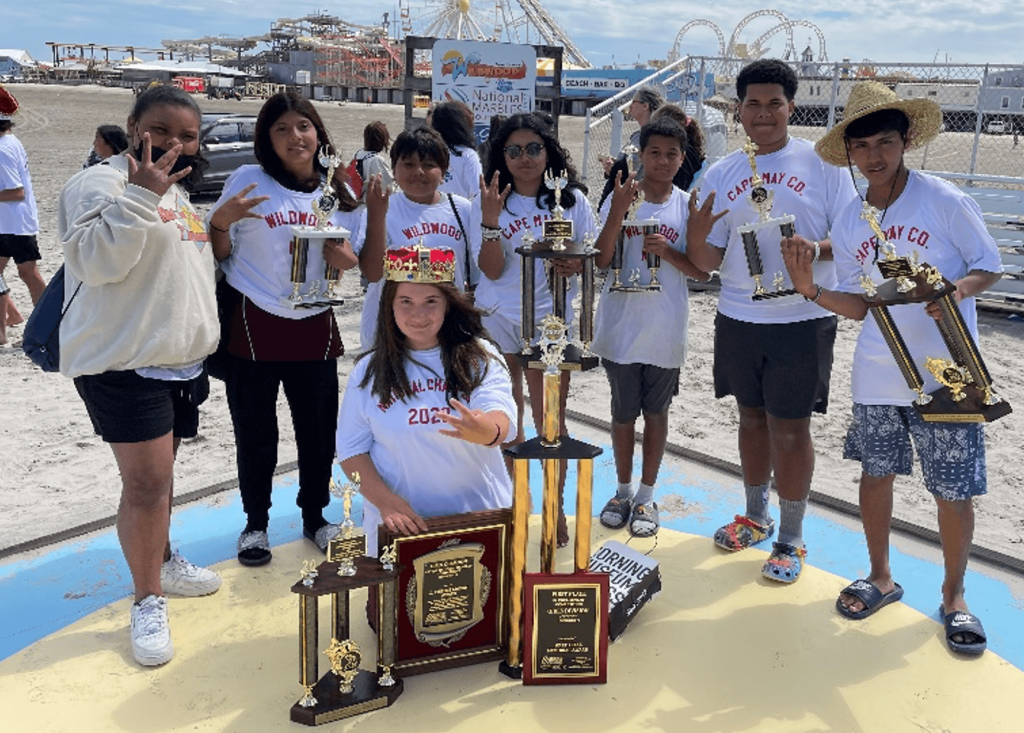 The 2022 National Marbles Tournament Queen Jessica Johnson (center front) is surrounded by her Cape May County and Wildwood teammates.  Standing (from left): Kirialis Estrada (Wildwood)