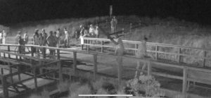 A surveillance camera captures a group of individuals gathered on the boardwalk outside the home of an Avalon resident