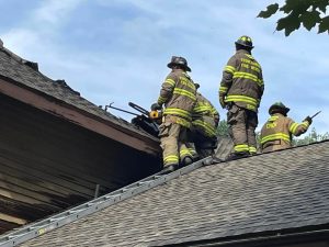 Stone Harbor firefighters offer assistance and operate on the roof of an extinguished blaze at 2 Maple Ct. in Court House