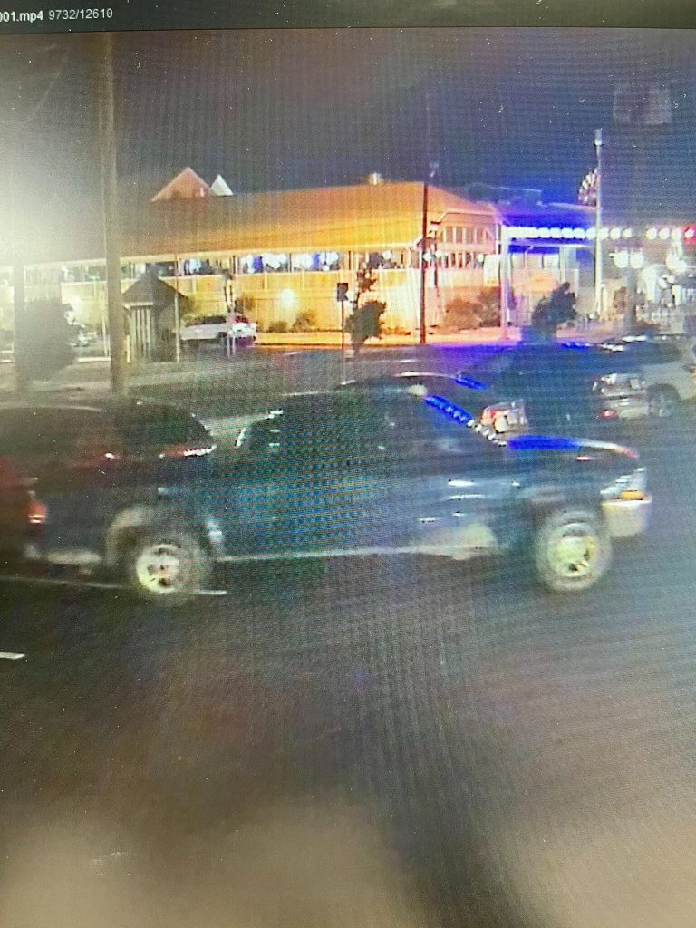 The vehicle used by the suspects is seen pulling out of a parking spot.