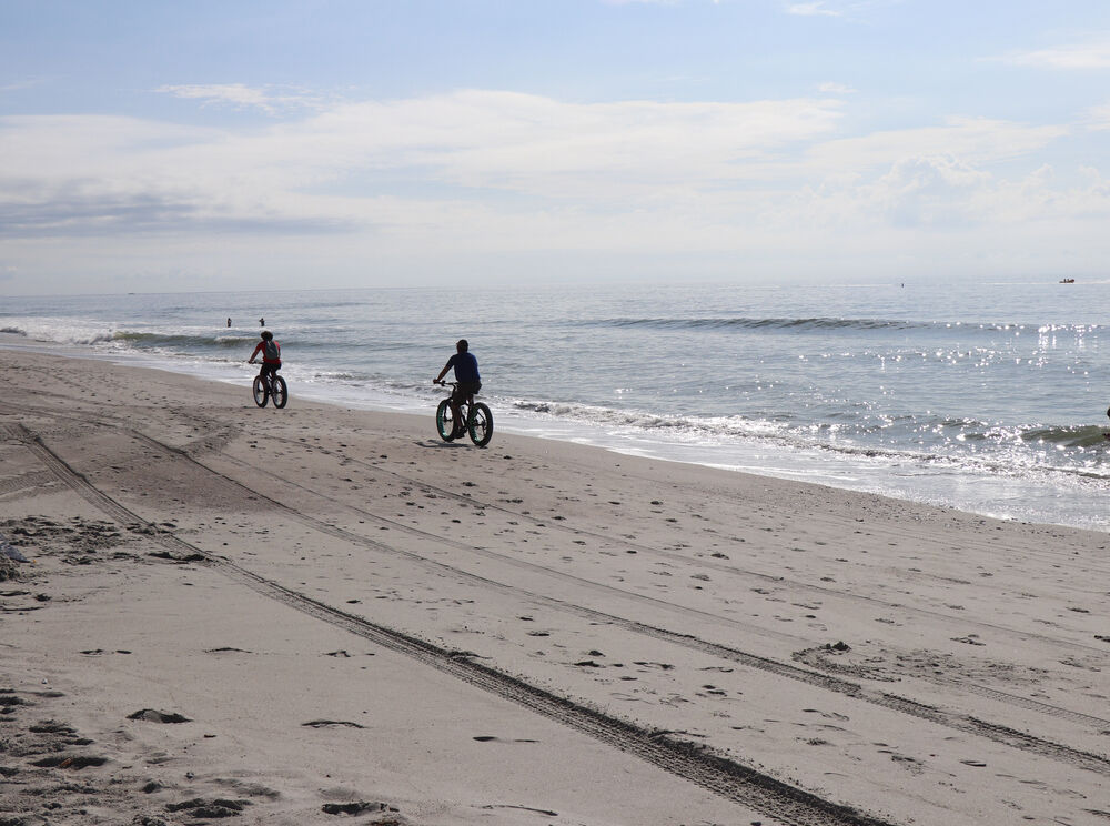 e-bike beach ride stock