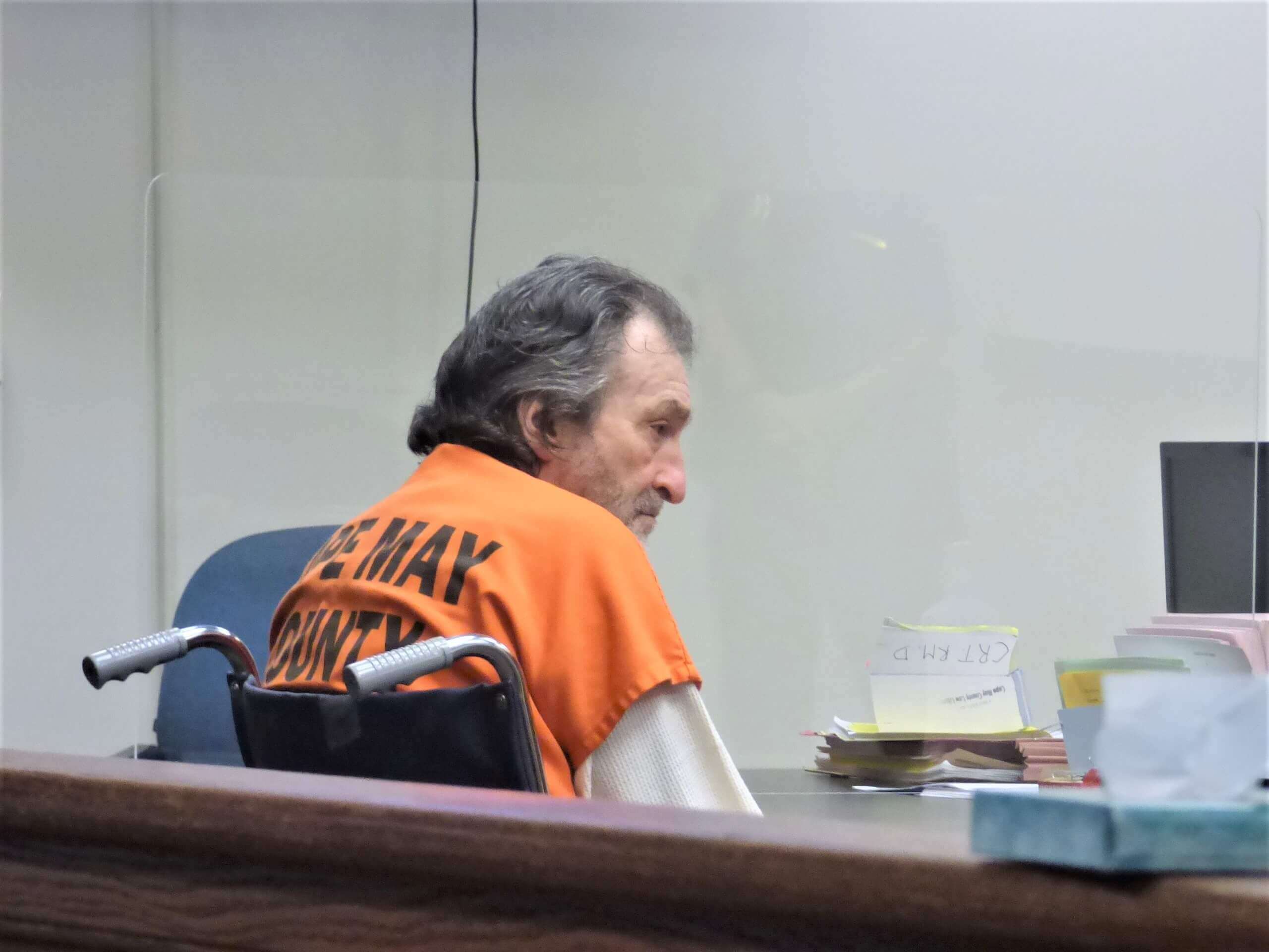 Jerry Rosado sits in a wheelchair at a hearing on his motion to dismiss