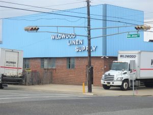 The sky-blue Wildwood Linen Supply building stands at the corner of New Jersey Avenue and Cardinal Road. The current redevelopment proposal would require the business to relocate.
