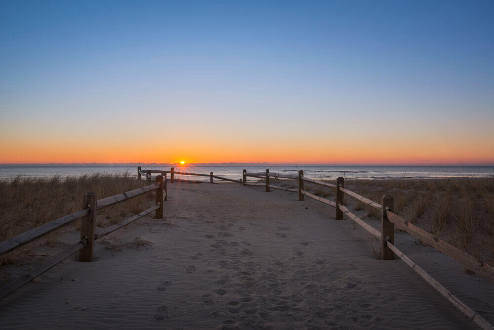 The sun rises over the ocean off Strathmere's beach in this stock image.