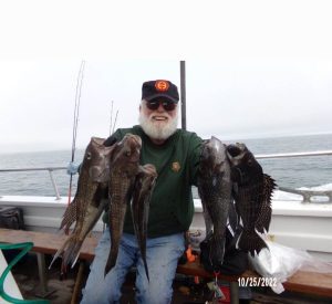 Paul Bodkin with two handfuls of sea bass.