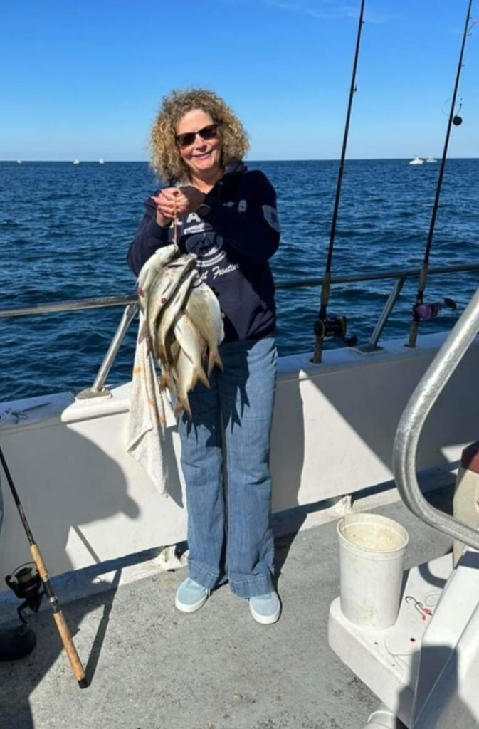 A happy lady-angler with a stringer of porgies.