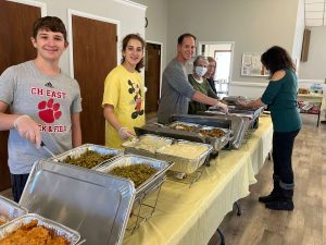 The Sukoneck family serves Thanksgiving dinner/William Matters (L) with Scott Carola (R)