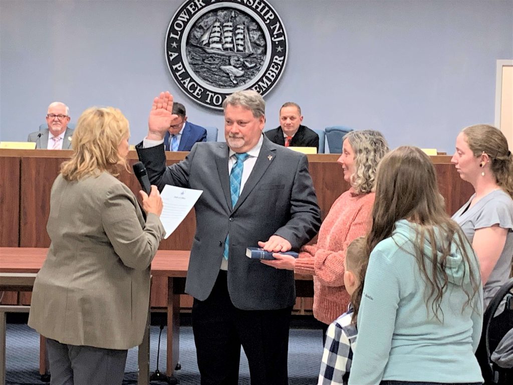 Lower Township First Ward Councilman Thomas Conrad is shown Jan. 4 taking the oath of office administered by County Commissioner E. Marie Hayes. Holding the Bible is Conrad’s wife