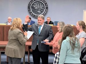 Lower Township First Ward Councilman Thomas Conrad is shown Jan. 4 taking the oath of office administered by County Commissioner E. Marie Hayes. Holding the Bible is Conrad’s wife
