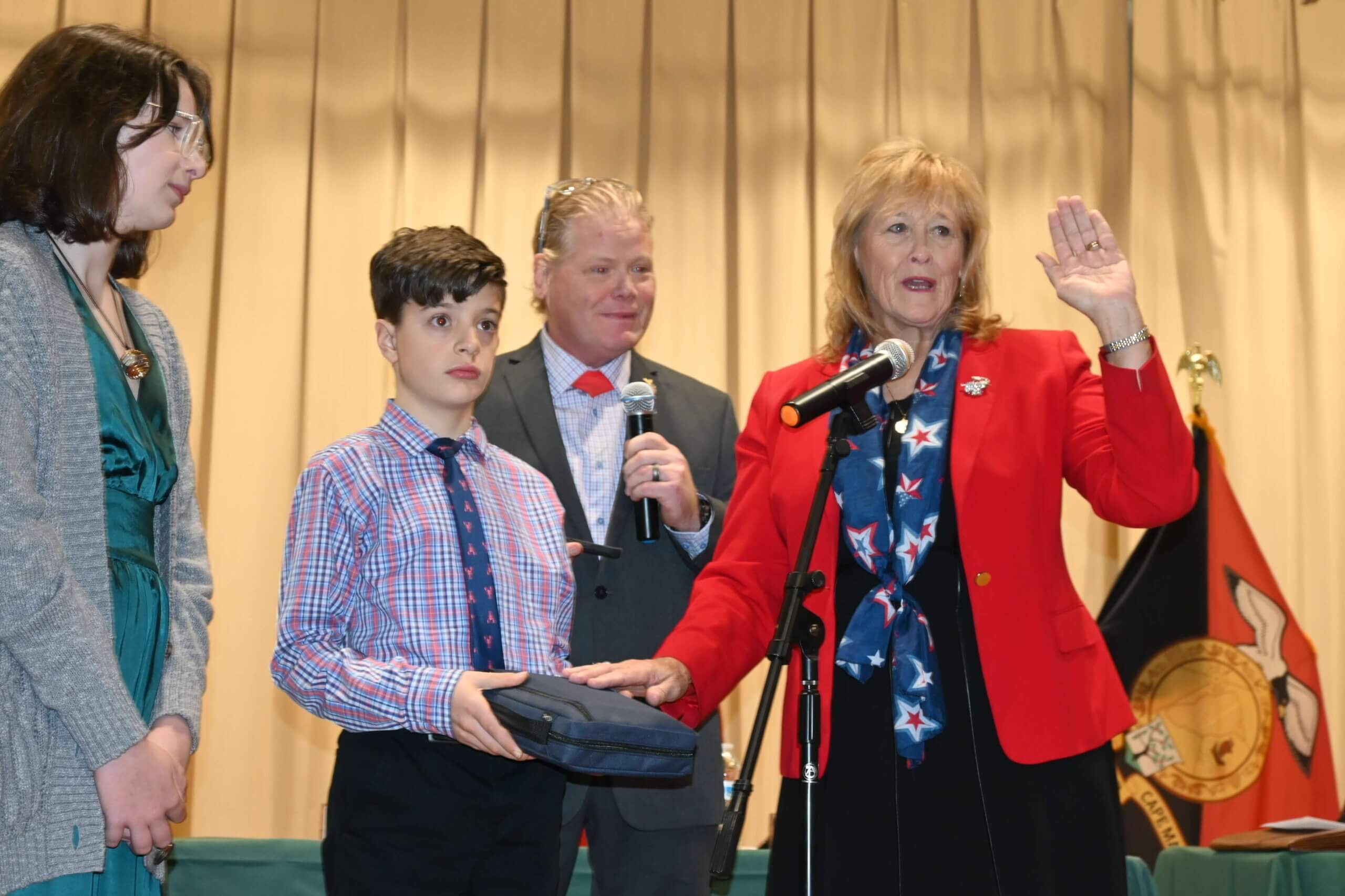 Commissioner Vice-Director E. Marie Hayes takes her oath from Assemblyman Erik K. Simonsen (R-1st) as her grandson