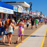 Folks enjoy a sunny summer’s day on the boardwalk in Wildwood.