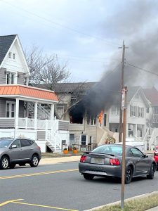 Flames are showing at a second-floor window at 932 Simpson Ave.