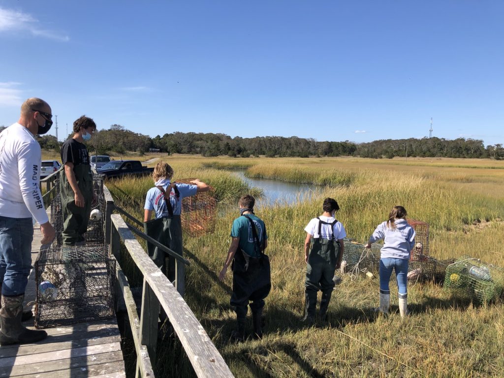 Students with Cape Tech’s natural science program pull up crab traps in the wetlands. Students will have even more ecology and water-related opportunities at Cape Tech