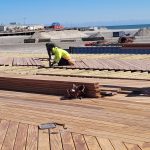 Workers replace decking on the Wildwood Boardwalk in March 2023 as part of an ongoing reconstruction project.