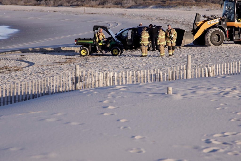 An unoccupied Toyota Highlander found partially submerged in the water on the Cove Beach in Cape May