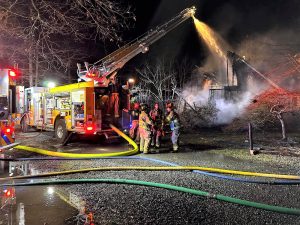 A fire crew douses the Tyler Road fire from above