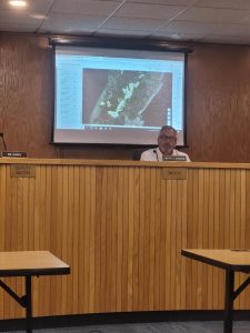 Shown is Mayor Tim Donohue with a center designation map behind him April 17.