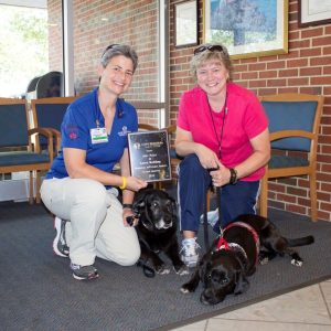 Volunteers Kiki Miller and Karen Wadding with their volunteer dogs.These furry friends make a big difference in patient morale at Cape Regional Medical Center.  