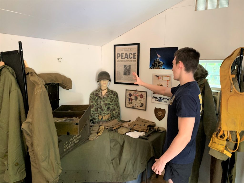 Simon Davies explains the military display for World War II in this corner of the military museum he set up at his home. 